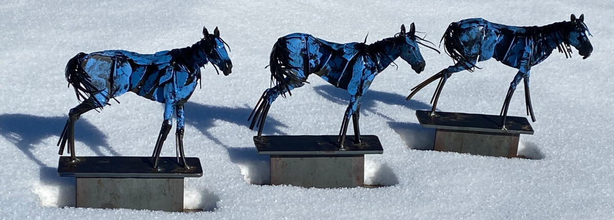 Three table-top size sculptures of the Bleu Horses by Jim Dolan