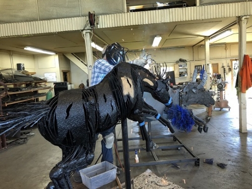 Image of Jim Dolan in his studio welding "Three Buck Truck" sculpture